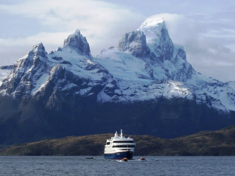 A ship sailing past large glaciers and fjords in Patagonia
